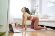 © ruben - YOUNG GIRL DOING YOGA AND PILATES IN THE LIVING ROOM OF HER HOME WITH THE COMPUTER