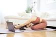 © ruben - YOUNG GIRL DOING YOGA AND PILATES IN THE LIVING ROOM OF HER HOME WITH THE COMPUTER