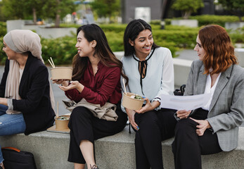 Wall Mural - Multiracial business women eating together outside of office