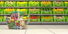 Shopping Basket Full Of Food In A Grocery Supermarket  Or Grocery Store With Shelves With Fruits And Vegetables.