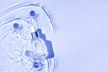 Wall Mural - Mockup of cosmetic glass blue bottle with pipette and serum on water surface with waves