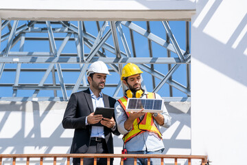 Wall Mural - Businessmen and engineers talking and checking quality power solar cell with digital tablet on construction site.