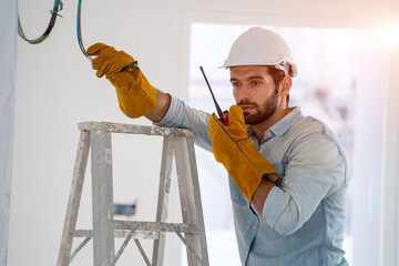 Aufkleber - Construction worker working on building site,House reconstruction,Repairing light at home,repair work.
