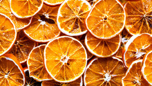 Dried orange. Dried orange slices background. High angle view. Top view of citrus fruit texture close-up. Selective focus included