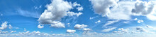 White Clouds Against Blue Sky Background