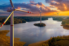 Wind Power Plant. Offshore Windmills. Several Windmills In River. Motor Wind Turbines Before Sunset. Ecological Power Generators. Green Energy. Renewable Power Plants. Wind Generators. 3d Image.