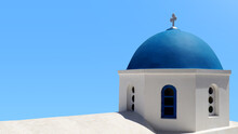 Closeup Of Santorini Blue Chapel Dome On Light Blue Sky