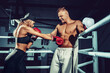 © zamuruev - Two sportsmans, woman and man boxers fighting in gloves. Boxing and fitness concept