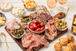 © netrun78 - Appetizers table with different antipasti, charcuterie, snacks, cheese. Finger food for buffet party. Traditional french or italian entires. Top view