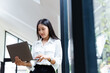 © Kannapat - Asian businesswoman working with laptop at office.