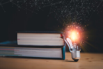 Wall Mural - Glowing lightbulb standing with books and connection line for education study can make imagination and creative thinking idea of problem solving concept.