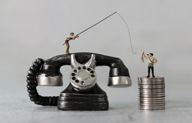 Black telephone and miniature people with business concept. The concept of financial fraud crime warnings.
