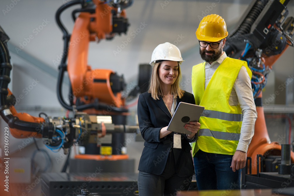 Chief engineer and project manager in modern industrial factory with ...