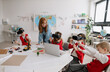 © Halfpoint - Happy schoolchildren wearing virtual reality goggles at school in computer science class
