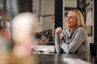 © Westend61 - Happy mature businesswoman sitting at desk in office