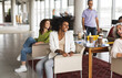 © Westend61 - Happy business colleagues sitting together at office