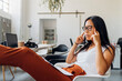 © Westend61 - Businesswoman with documents having headache at workplace