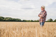 © Westend61 - Farmer with arms crossed standing in farm