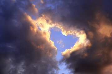 Poster - Heart in cloud. Heart shaped hole in stormy sky.  Valentine background with copy space for text