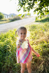 Wall Mural - Baby girl plays in nature