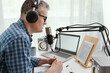 © StockPhotoPro - Professional speaker checking the podcast schedule