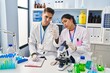 © Krakenimages.com - Man and woman scientists partners analysing blood test tube at laboratory