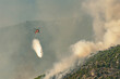 Fire helicopter spraying water at Geraneia mountain to eliminate the fire.
