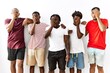 Young african group of friends standing together over isolated background yawning tired covering half face, eye and mouth with hand. face hurts in pain.