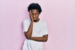 © Krakenimages.com - Young african american man wearing casual white t shirt thinking looking tired and bored with depression problems with crossed arms.