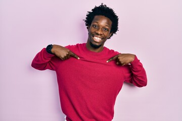 Wall Mural - Young african american man wearing casual clothes looking confident with smile on face, pointing oneself with fingers proud and happy.