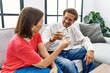 © Krakenimages.com - Middle age man and woman couple smiling confident toasting with champagne at home