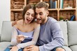 © Krakenimages.com - Young caucasian couple surprised looking pregnant test result at home.