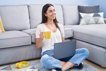 Canvas Print - Young hispanic woman using laptop drinking coffee at home