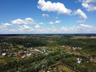  Countryside landscape with many private houses with homesteads in the the middle band of Russia in the bright sunny summer day aerial view