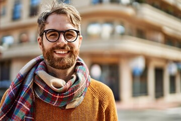 Wall Mural - Young caucasian man with beard wearing glasses outdoors on a sunny day