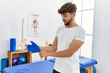 Sticker - Young arab man patient smiling confident wearing glove at clinic