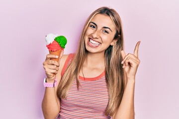 Poster - Beautiful hispanic woman holding ice cream smiling happy pointing with hand and finger to the side