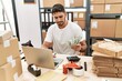 © Krakenimages.com - Handsome hispanic man working doing countability at e-commerce store