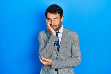 Sticker - Handsome man with beard wearing business suit and tie thinking looking tired and bored with depression problems with crossed arms.