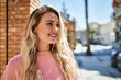 © Krakenimages.com - Young blonde woman smiling at the city