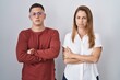 © Krakenimages.com - Mother and son standing together over isolated background skeptic and nervous, disapproving expression on face with crossed arms. negative person.