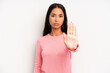 © kues1 - hispanic pretty woman looking serious, stern, displeased and angry showing open palm making stop gesture
