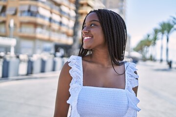 Sticker - Young african american girl smiling happy standing at the city.