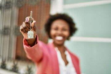 Young african american woman holding keys outdoor