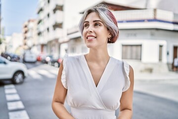 Sticker - Young caucasian girl smiling happy standing at the city.