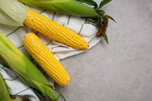 Top View Of Ripe Sweet Corn Cob On Kitchen Textile Copy Space