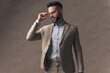 © Viorel Sima - unshaved businessman looking to side and adjusting glasses