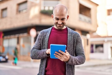 Sticker - Young man smiling confident using touchpad at street