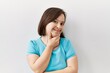 © Krakenimages.com - Young down syndrome woman standing over isolated background looking confident at the camera smiling with crossed arms and hand raised on chin. thinking positive.