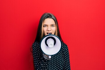 Wall Mural - Young teenager girl shouthing and screaming with megaphone